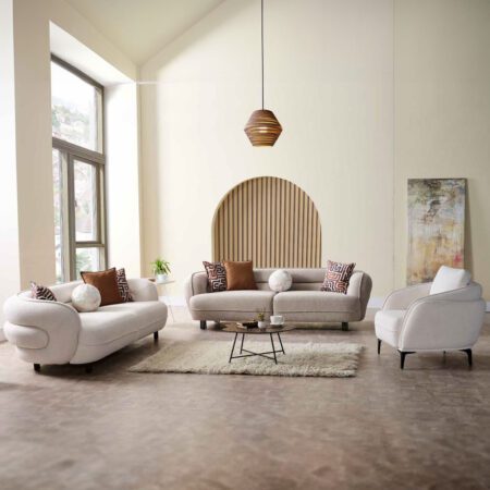 Modern living room with cozy beige seating group, decorative pillows, and minimalist coffee table